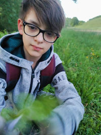 Portrait of boy wearing sunglasses on field