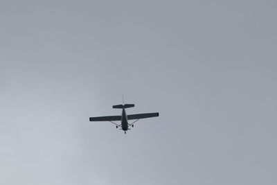 Low angle view of airplane against clear sky