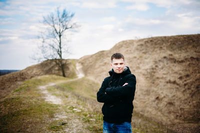 Portrait of young man standing on land