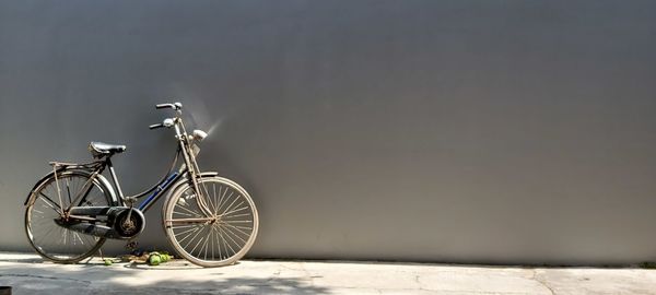 Bicycle parked against wall