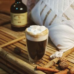 Close-up of irish coffee drink on bamboo crate