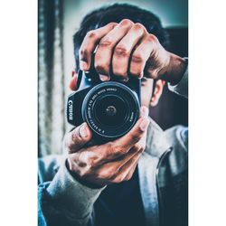 Midsection of person holding camera