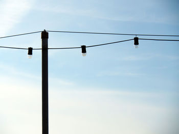 Low angle view of power lines against sky