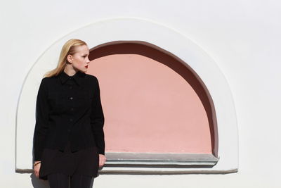 Woman standing against wall