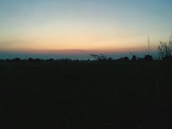 Scenic view of field against sky during sunset