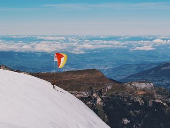 Scenic view of mountains against cloudy sky