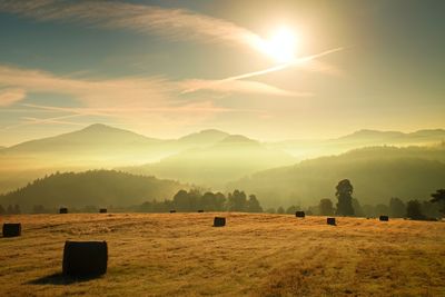 Harvested autumn field against daybreak sky, amazing nature show