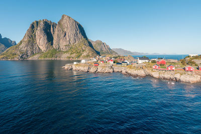 Colorful fisherman's wooden houses in village of reine in lofoten in the golden hour