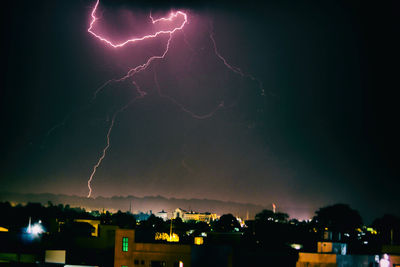 Lightning in sky over city at night