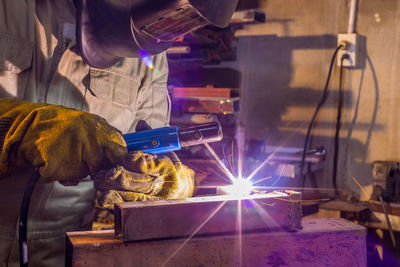 Welder welding in workshop