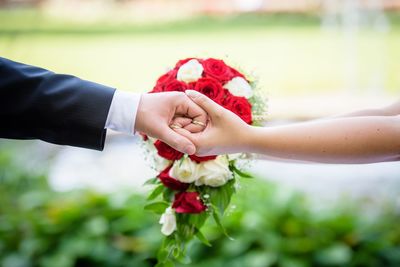 Midsection of bride holding bouquet