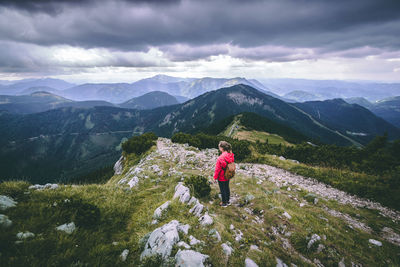Rear view of person on mountains against sky