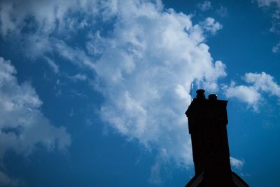 Low angle view of silhouette statue against sky