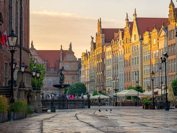 Buildings in city at sunset