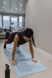 View of woman exercising at home