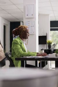 Businesswoman using laptop at office