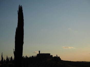 Low angle view of built structure against sky at sunset