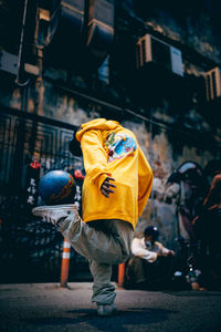 Rear view of man walking on street