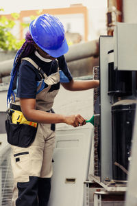 Rear view of man working at construction site