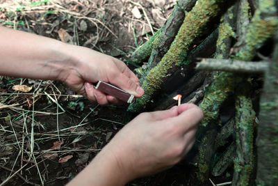 Burning matches in the hands . setting fire logs for picnic