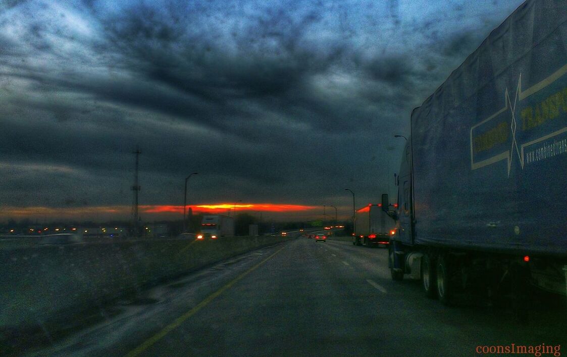 transportation, the way forward, sky, road, cloud - sky, diminishing perspective, cloudy, weather, vanishing point, road marking, street, storm cloud, illuminated, overcast, dusk, dramatic sky, sunset, car, land vehicle, building exterior