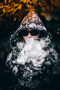 Close-up of man smoking in water