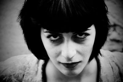 Close-up portrait of serious young woman standing outdoors