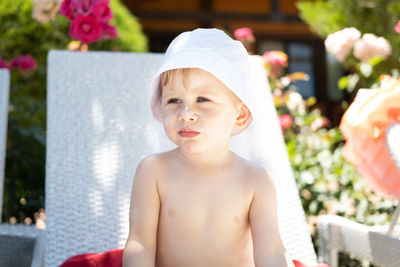 Boy wearing hat looking away outdoors