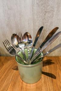 High angle view of cutlery in container on table