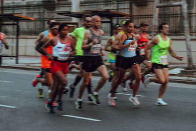 Group of people running in city