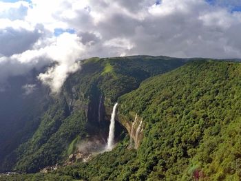 Scenic view of waterfall against sky