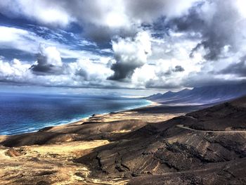 Scenic view of sea against cloudy sky