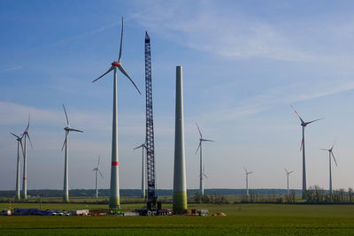 Windmill on field against sky