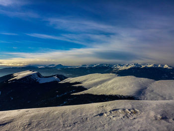 Scenic view of mountains against sky during winter