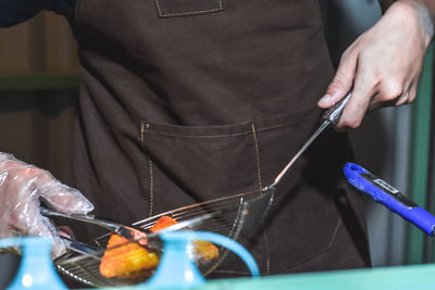 Midsection of man preparing food