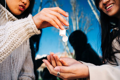 Midsection of couple holding hands