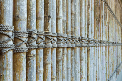 Close-up of rope tied up on wood