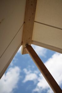 Low angle view of wood against sky