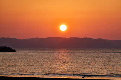 Scenic view of sea against romantic sky at sunset