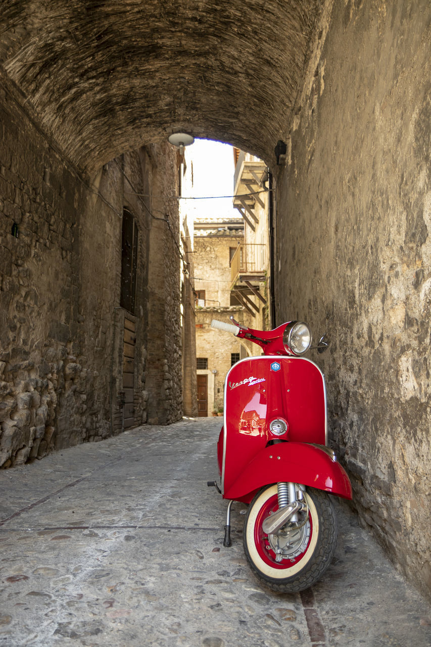 RED VINTAGE CAR IN ALLEY