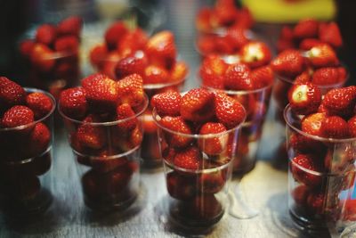 Close-up of strawberries in glasses on table