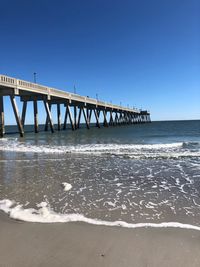 View of bridge over sea against clear sky