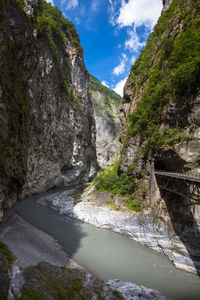 Scenic view of lake by mountain against sky