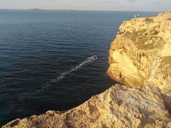 High angle view of rocks on beach against sky