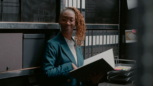 Portrait of young businesswoman standing in office