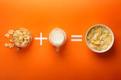 High angle view of drink on table against orange background