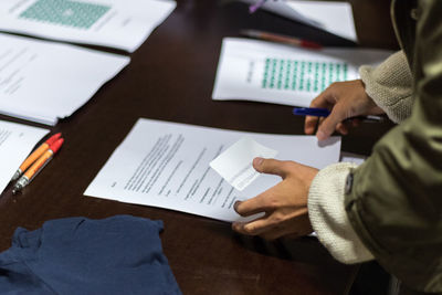 Close-up of business person working at desk in office