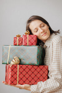 Portrait of smiling young woman sitting on sofa at home