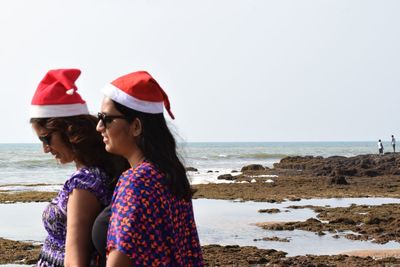 Woman on beach against clear sky