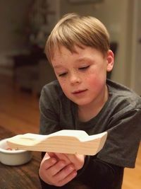 Close-up of boy on table